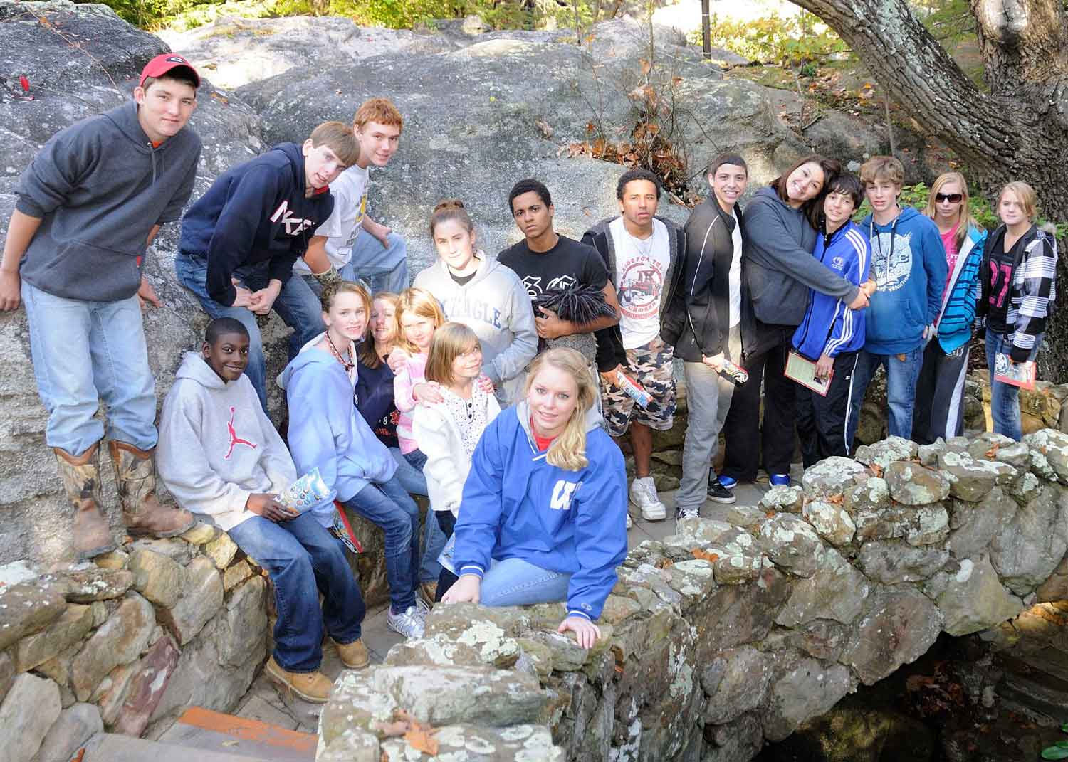 Residents of the masonic home of georgia hangout on a rock bridge at a state park.