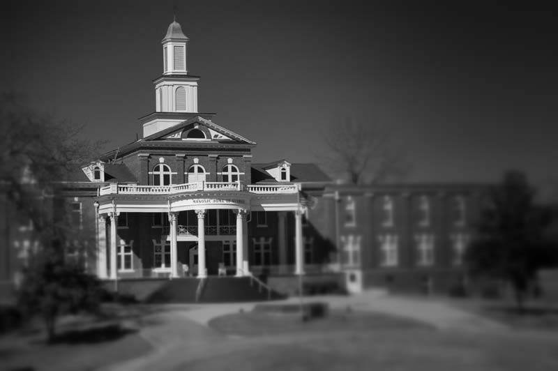 A black and white photo showing the facade of the Masonic Home of Georgia.